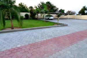 a parking lot with a car parked in a yard at Artem Apartments - Apartment 3 in Kitwe