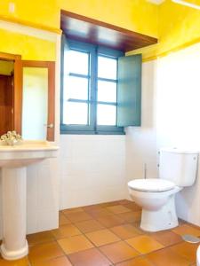 a bathroom with a toilet and a sink at Luxurious Villa in Outeiro - Private Pool in Santa María La Mayor del Rosario +21 photos