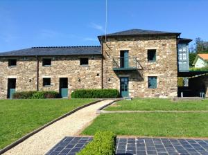 a stone house with a walkway in front of it at Luxurious Villa in Outeiro - Private Pool in Santa María La Mayor del Rosario