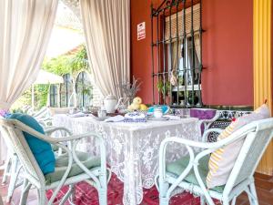 a dining room with a white table and chairs at 4 bedrooms villa with private pool enclosed garden and wifi at Los Palacios y Villafranca in Los Palacios y Villafranca