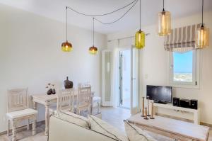 a living room with a table and a dining room at Spacious Villa in Naxos with Sea View in Naxos Chora +18 photos