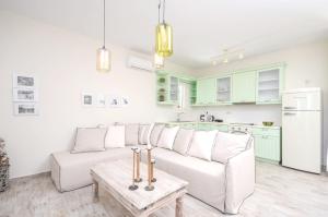 a living room with a white couch and green cabinets at Spacious Villa in Naxos with Sea View in Naxos Chora