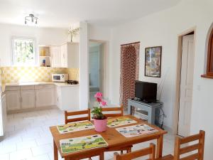 a kitchen with a table and chairs and a dining room at Maison d'une chambre avec vue sur la mer jardin amenage et wifi a Alata a 8 km de la plage in Alata