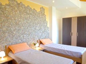 A bed or beds in a room at Spacious Apartment in Zafferana Etnea 65 m² with Private Garden