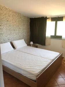 A bed or beds in a room at Spacious Apartment in Zafferana Etnea 65 m² with Private Garden