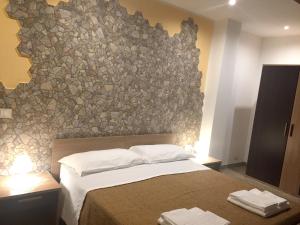 A bed or beds in a room at Spacious Apartment in Zafferana Etnea 65 m² with Private Garden
