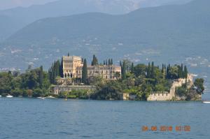 a large building on an island in the water at The Swan B&B in Manerba del Garda