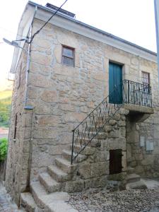a stone building with stairs and a blue door at One bedroom apartement with city view balcony and wifi at Alvoco da Serra in Alvoco da Serra