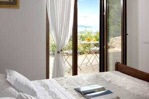 a bedroom with a bed and a view of a patio at Panoramic Villa in Prgomet, Sea View and Private Pool in Plano +89 photos