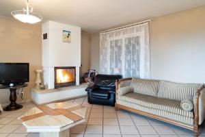 a living room with a couch and a fireplace at Maison chaleureuse Saint-Cyr-sur-le-Rhône in Saint-Cyr-sur-le-Rhône
