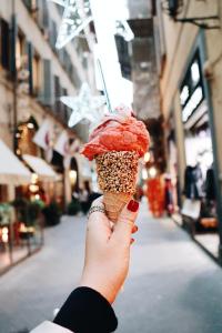 a person holding up a red ice cream cone at Charming House in Sciacca with Multiple Views in Sciacca