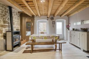 a kitchen with a table and a stove at Maison charmante à Valprivas avec jardin privé. in Valprivas