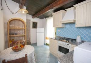 a kitchen with a table with a bowl of fruit on it at Modern Villa in Olbia with Shared Pool - 45 sqm in Porto Rotondo