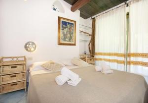 a bedroom with two beds and a dresser at Modern Villa in Olbia with Shared Pool - 45 sqm in Porto Rotondo +36 photos