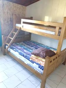 a wooden bunk bed in a room at Maison de 3 chambres avec vue sur la mer jardin clos et wifi a La Plaine des Cafres in La Plaine des Cafres