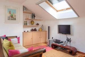 a living room with a couch and a television at Sunny Villa in Comporta with Private Pool in Montalvo