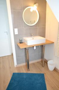 a bathroom with a sink and a mirror at Maison charmante avec vue sur la mer à Locquirec in Locquirec +5 photos
