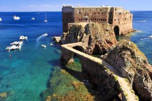 a castle in the ocean with sheep in the water at Bungalow with Shared Pool in Pataias + 30 m² + Pool. in Pataias