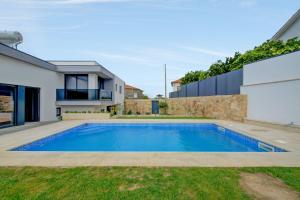 a swimming pool in the backyard of a house at 3 bedrooms villa with private pool enclosed garden and wifi at Esposende in Esposende