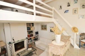 a living room with a staircase and a couch at Maison accueillante avec jardin, Sainte-Marie-de-Ré in Sainte-Marie-de-Ré