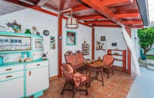 a kitchen and dining room with a table and chairs at 4 bedrooms villa with private pool enclosed garden and wifi at Jezera in Jezera