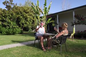 a man and a woman sitting at a table at White Elephant Accomodation in Motueka