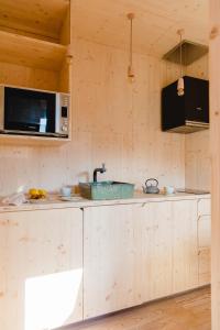 a kitchen with a sink and a microwave at Elegant Apartment Alvados 50m² + Pool in Alvados