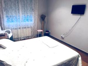 a hospital room with a bed and a tv at Spacious House in Molinaseca with Mountain View in Molinaseca