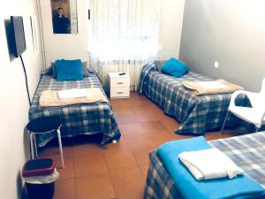 a room with three beds and a tv in it at Spacious House in Molinaseca with Mountain View in Molinaseca