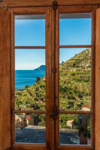 an open window with a view of the ocean at Luxury Seaview Apartments Manarola by Arbaspàa in Manarola