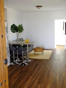 a living room with a table and a potted plant at La Cabaña in Guía de Isora