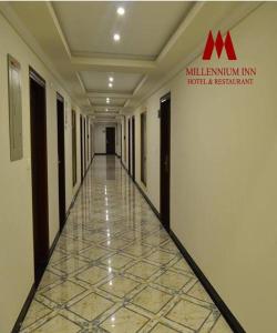 a hallway of a building with a sign on the wall at Millennium Inn Naran in Mānsehra