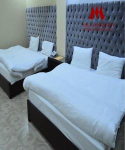 Кровать или кровати в номере Millennium Inn Naran