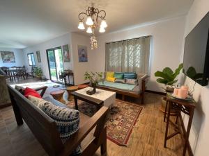 a living room with a couch and a table at Miggi's Home in Mae On