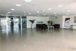 a large room with a lobby with a table and chairs at OYO 606 Home B 1613 Lakeside Tower, IMPZ in Dubai