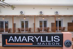 a sign in front of a building with a restaurant at Amaryllis Maison Hili in Alexandroupoli