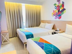 Postel nebo postele na pokoji v ubytování Dafam Express Jaksa Jakarta + 27 fotografií