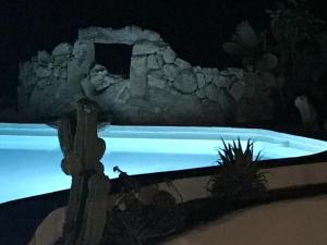 a painting of a swimming pool at night at CA' LA SOMARA in San Pantaleo
