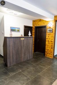 a lobby with a counter and two doors at Casa Raisa in Buşteni