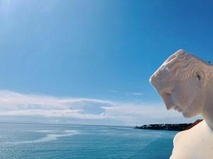a statue of a woman looking at the ocean at Les Remparts Antibes Location in Antibes