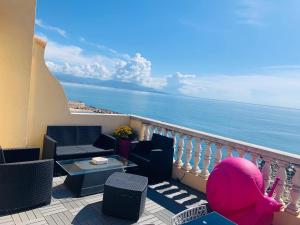 a balcony with chairs and a table and the ocean at Les Remparts Antibes Location in Antibes