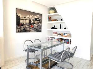 a dining room with a glass table and chairs at Les Remparts Antibes Location in Antibes