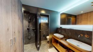 a bathroom with two sinks and a shower at Paravicini 5 in St. Moritz +6 photos