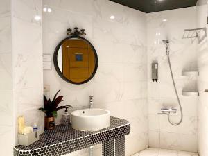 a bathroom with a sink and a mirror at The First Nanwan Hostel in Nanwan