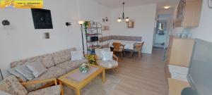 a living room with a couch and a table at Apartment Petra by FiS - Fun in Styria in Bad Mitterndorf