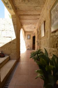 a hallway in a building with a stone wall at 400YR Farmhouse in Xaghra Gozo - Entire Farmhouse in Tal-Barmil