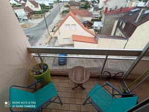 a balcony with two chairs and a view of a street at Chez Lilie, Studio cosy Plage de Stella in Cucq