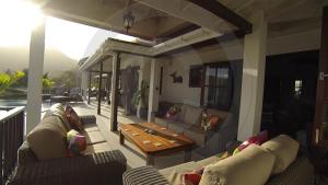 a living room with couches and a wooden table at IJEOMA HOUSE in Bequia