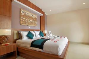 - une chambre avec un lit orné de roses rouges dans l'établissement Villa Wananta, à Ubud