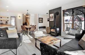 a living room with a couch and a stove at Chalets Alpins - 12 Chemin Alpin in Stoneham